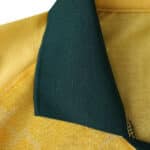 Close-up of AC Milan Third 2025/26 Player Version jersey collar in yellow with green inner lining.