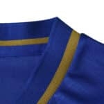 Close-up of AS Monaco Away 2025/26 Fan Version jersey collar in blue with a gold stripe detail.