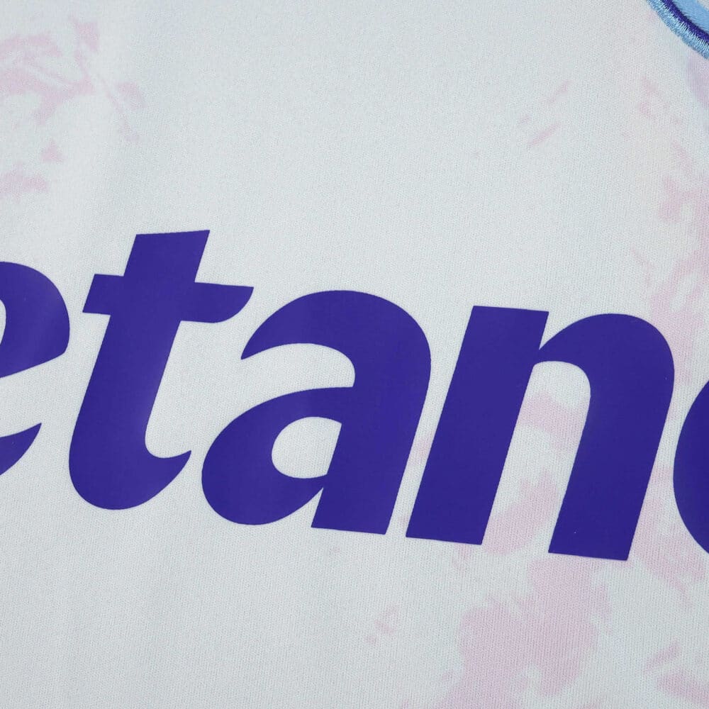 Close-up of the Aston Villa Third 2025/26 Fan Version jersey showing part of the sponsor logo in purple.