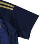 Detail of the Fenerbahce Third 2025/26 Fan Version jersey sleeve with gold stripes on dark blue fabric.