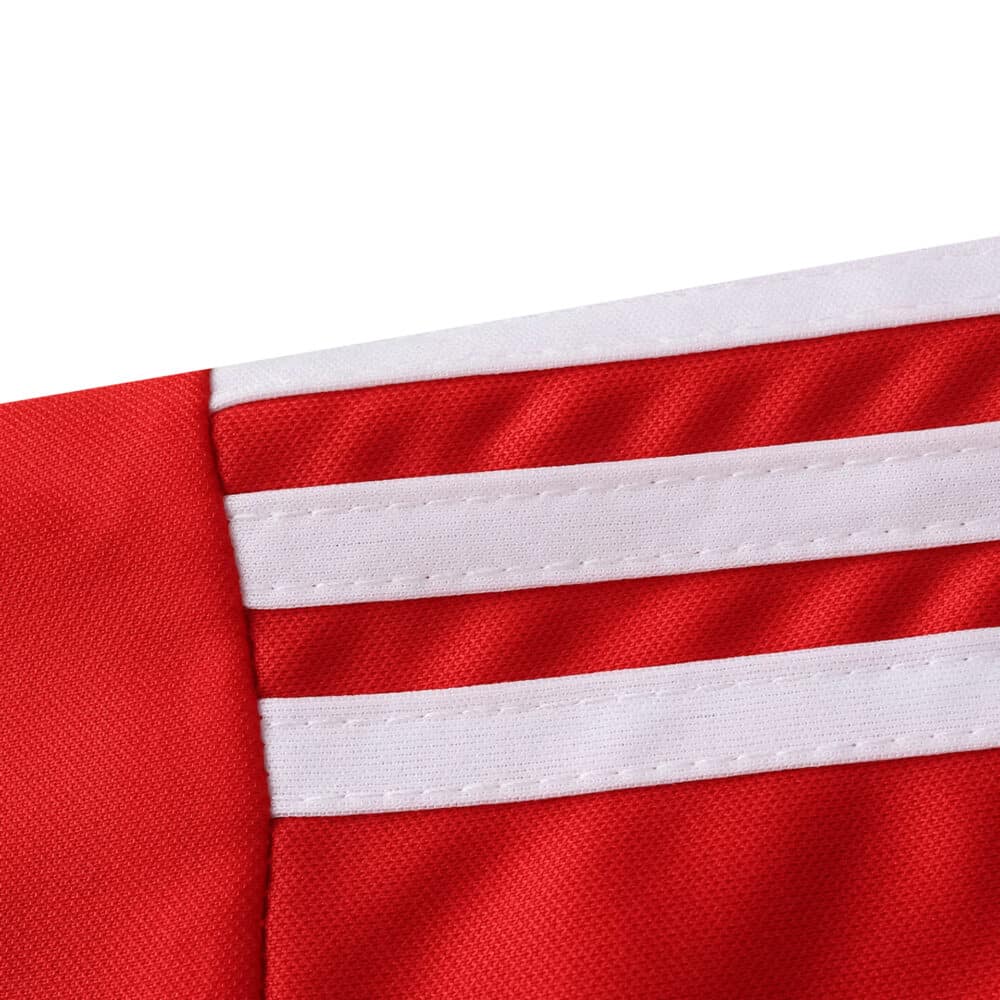 Close-up of the 2025/26 Granada Home Fan Version jersey showing red fabric with three white shoulder stripes.