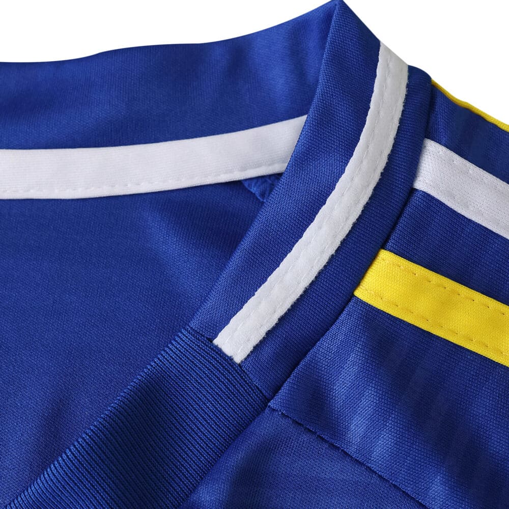 Close-up of Leeds United Away 2025/26 Fan Version jersey collar in blue with white and yellow trim.