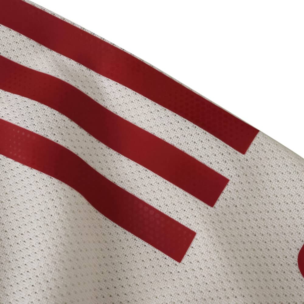 Close-up of Liverpool Away 2025/26 Player Version jersey showing red stripes on white textured fabric.