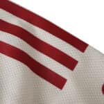 Close-up of Liverpool Away 2025/26 Player Version jersey showing red stripes on white textured fabric.