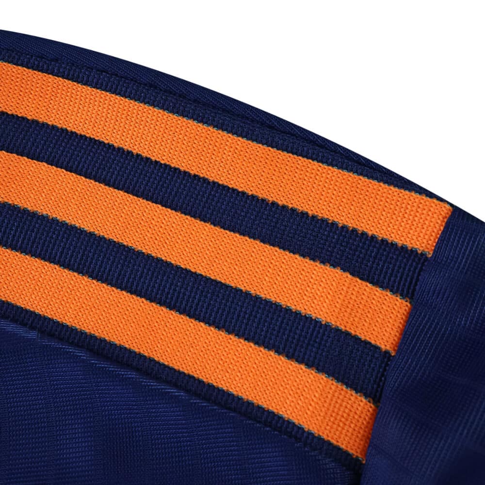 Close-up of Newcastle United Third 2025/26 Player Version shoulder with orange and navy stripes.