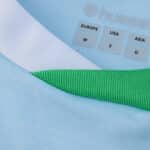 Close-up of the Real Betis Away 2025/26 Fan Version jersey collar and size tags.