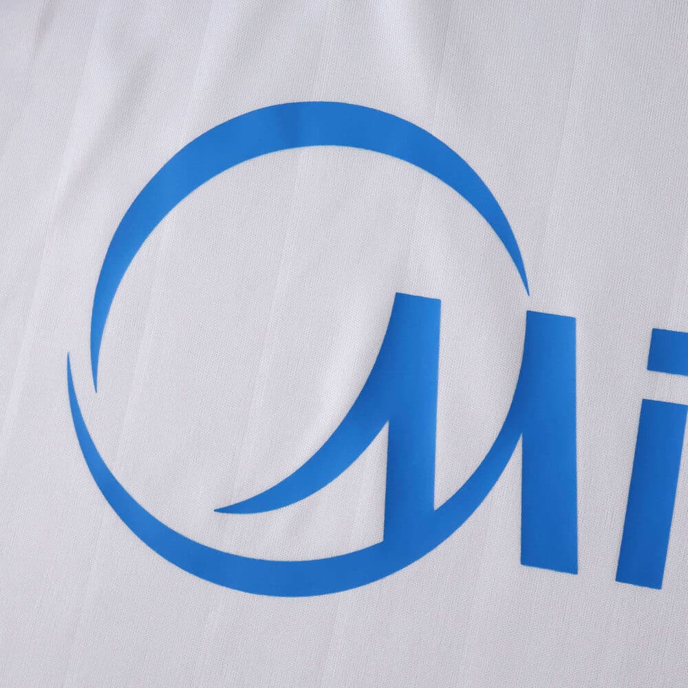 Close-up of the Sevilla FC 2025/26 home fan jersey showing a blue sponsor logo detail on white fabric.