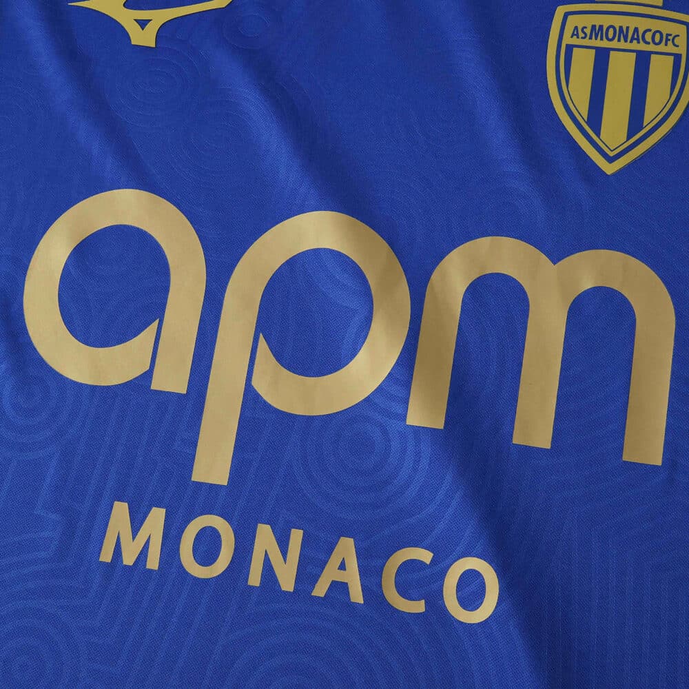 Close-up of the AS Monaco Away 2025/26 Fan Version jersey featuring sponsor logo and club crest.