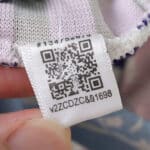 Close-up of the Aston Villa Third 2025/26 Player Version shirt tag with QR code and serial number.