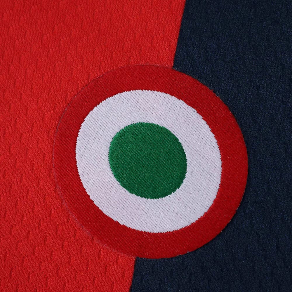 Close-up of Bologna Home 2025/26 Fan Version jersey, featuring a round green, white, and red badge.