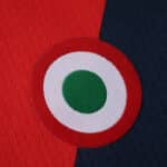 Close-up of Bologna Home 2025/26 Fan Version jersey, featuring a round green, white, and red badge.