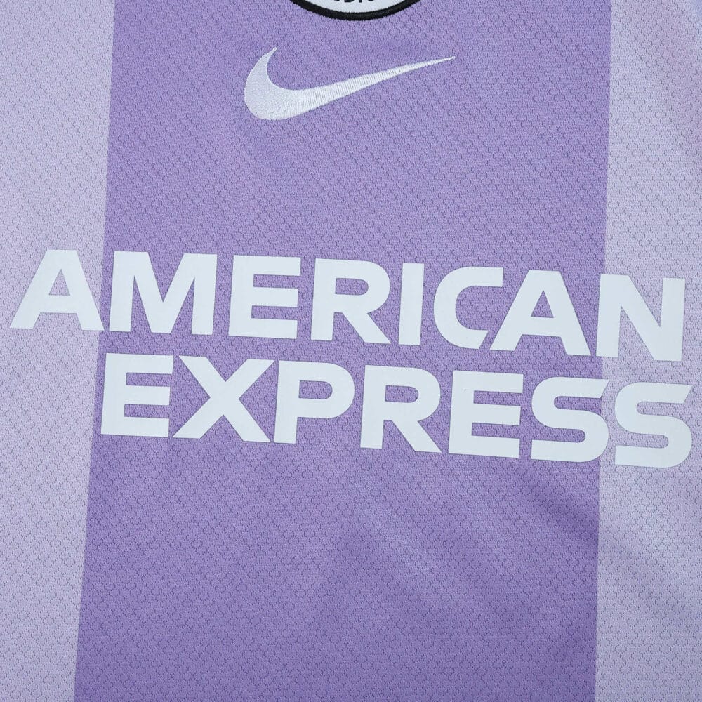 Close-up of Brighton & Hove Albion 2025/26 away fan jersey with Nike logo and American Express sponsor.