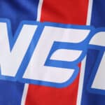 Close-up of the Crystal Palace 2025/26 home fan jersey, showing blue, red stripes and part of the sponsor logo.