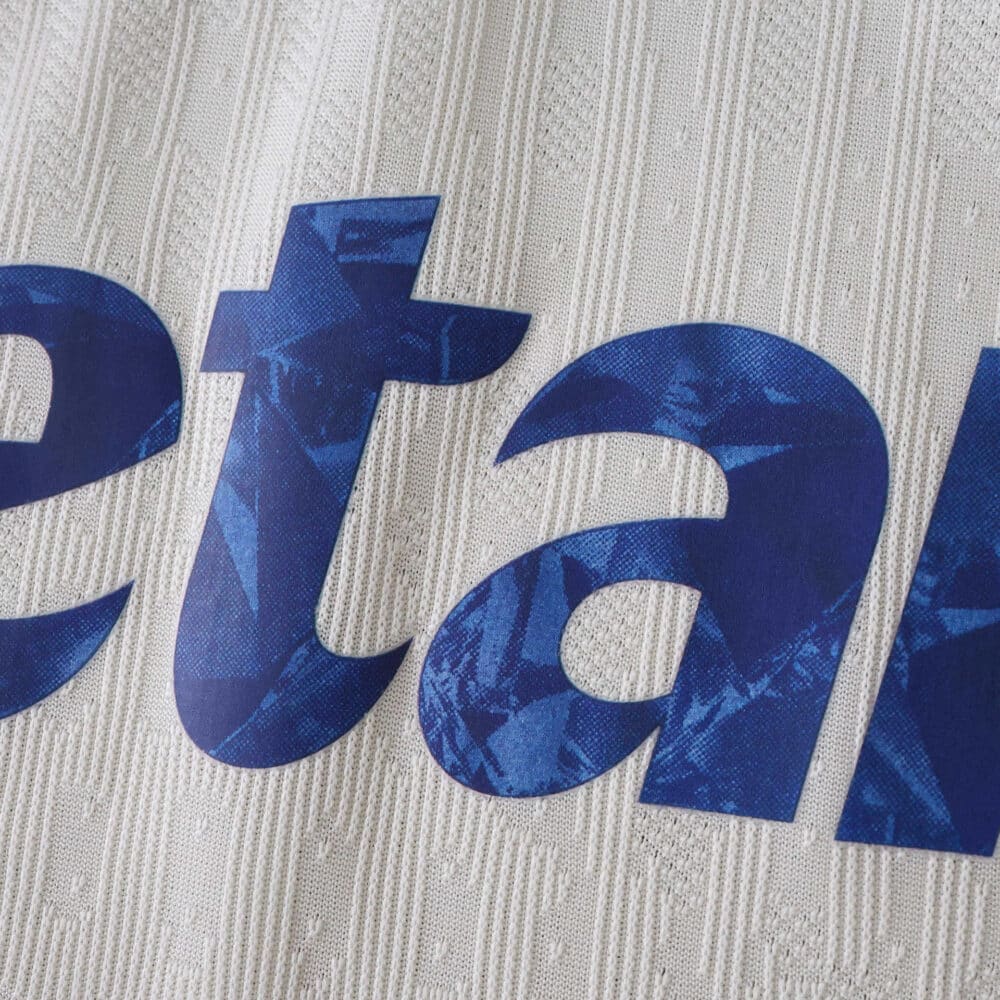 Close-up of FC Porto Third 2025/26 Player Version jersey showing textured fabric and blue printed text.