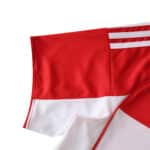 Close-up of the Granada Home 2025/26 Fan Version jersey sleeve in red and white with stripe detail.