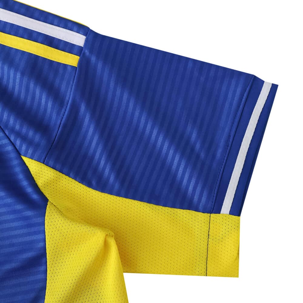 Close-up of Leeds United 2025/26 away fan jersey sleeve in blue and yellow with white stripes