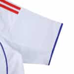 Close-up of the Olympique Lyonnais 2025/26 home fan jersey sleeve with red stripes and blue trim.