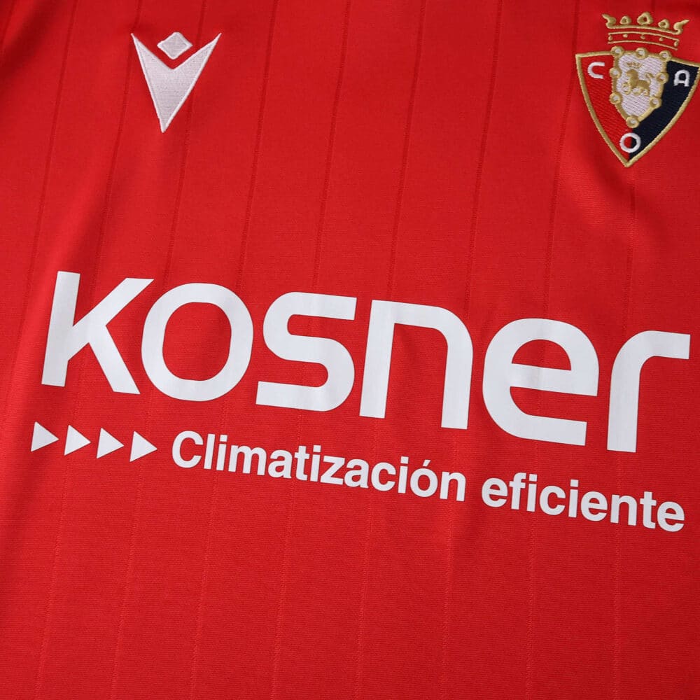 Close-up of the Osasuna 2025/26 home fan jersey featuring the club crest and main sponsor logos.