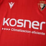 Close-up of the Osasuna 2025/26 home fan jersey featuring the club crest and main sponsor logos.