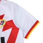 Detail of the Rayo Vallecano 2025/26 home fan jersey showing the sleeve, crest, and red lightning design.
